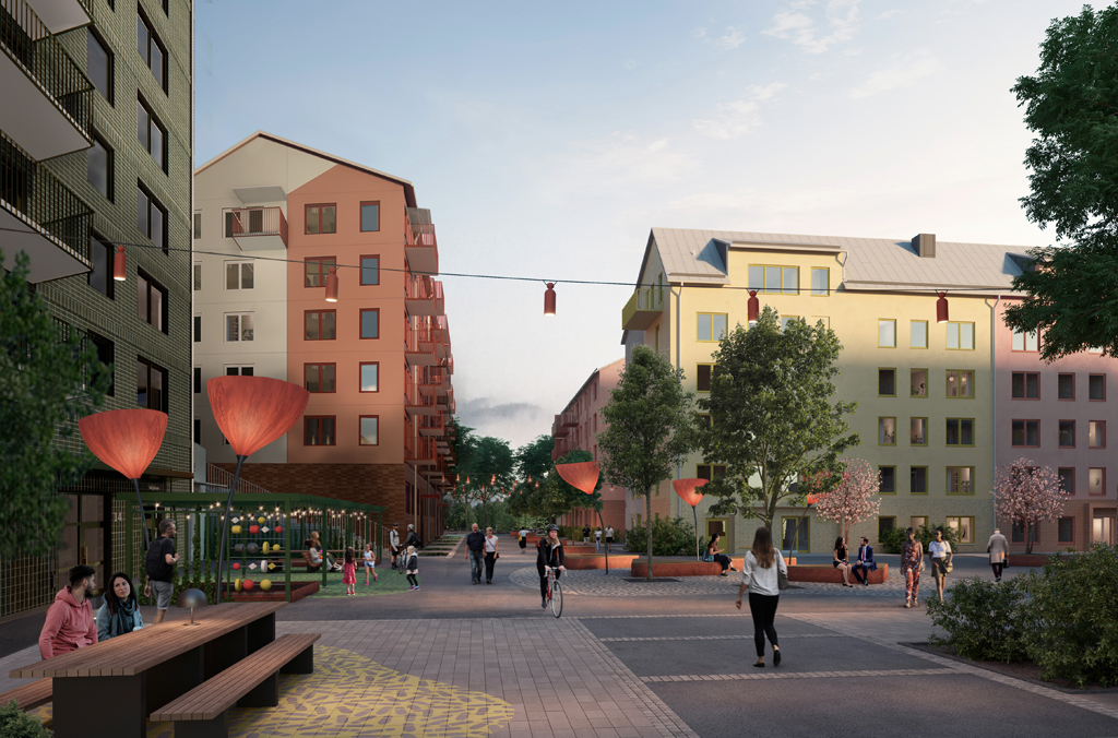 Flerbostadshus i rött, grönt, gult och rosa kring ett stenlagt torg med människor som går, cyklar och sitter vid ett bord.